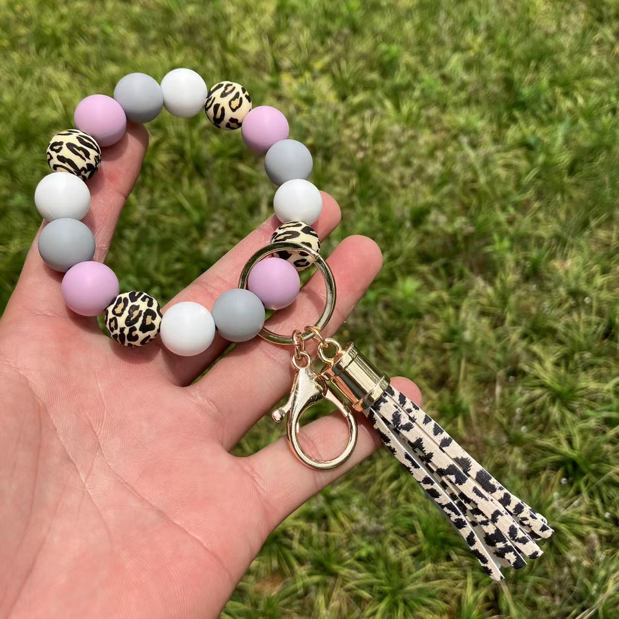 Comercio al por mayor leopardo girasol borla de silicona con cuentas llavero de muñeca